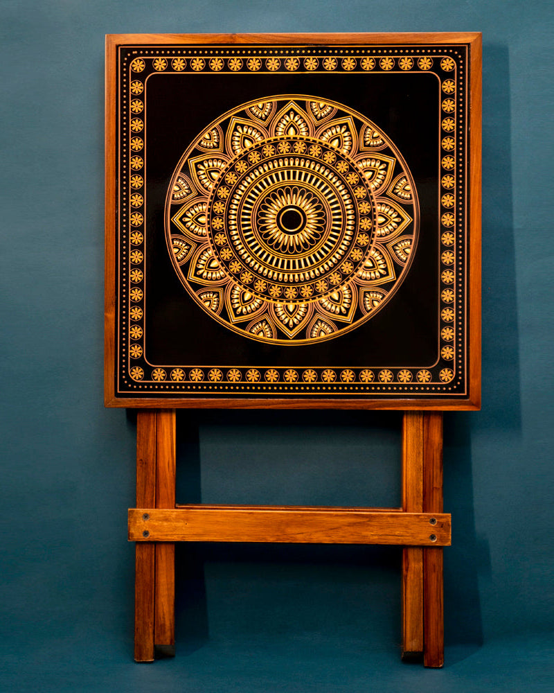 Enjoy the ease of complete foldability and effortless cleaning and maintenance. Elevate your surroundings with our Gold and Black Square Folding Table, designed for serenity. Crafted from teak wood and featuring Mandala Art.