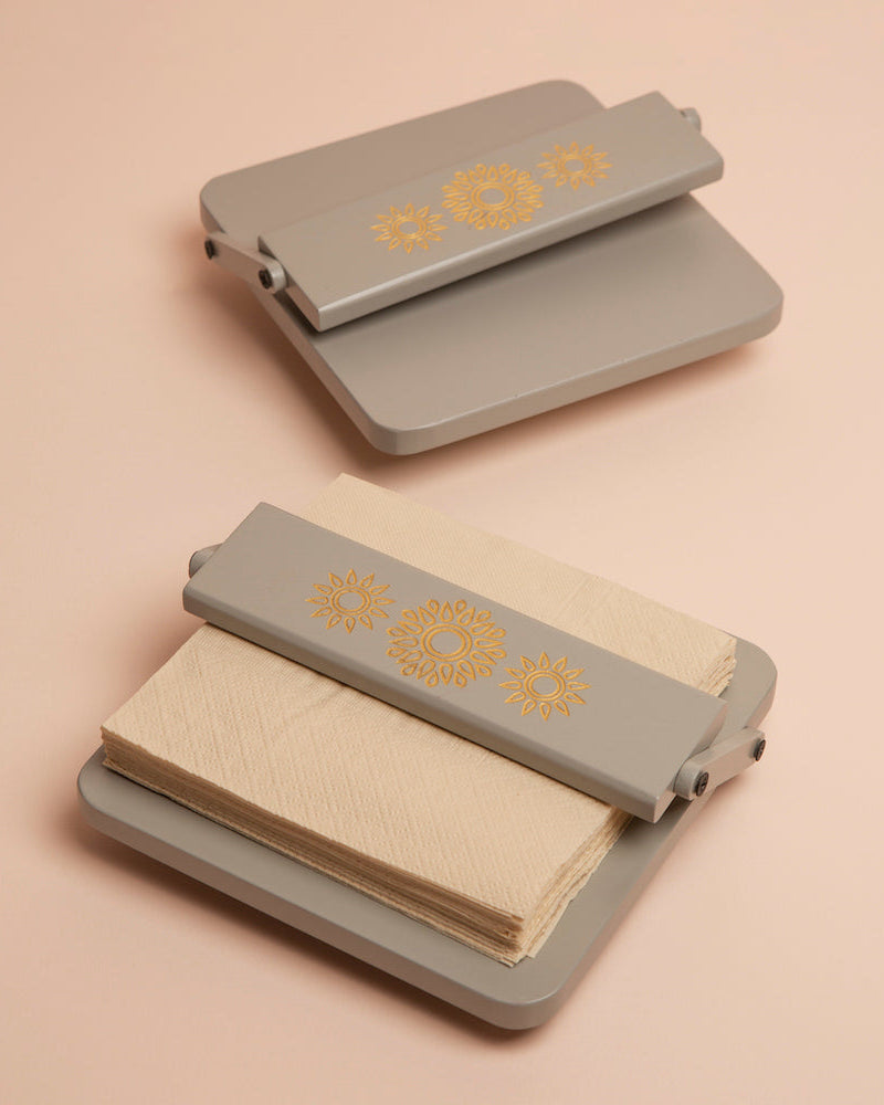 Transform your tissue organization with the Pebble Grey Tissue Tray, a sophisticated accessory crafted from High-Quality Wood. Featuring Serenity Mandal Art and an adjustable flap to secure square tissues, this tray effortlessly combines style and chaos-resistant functionality.