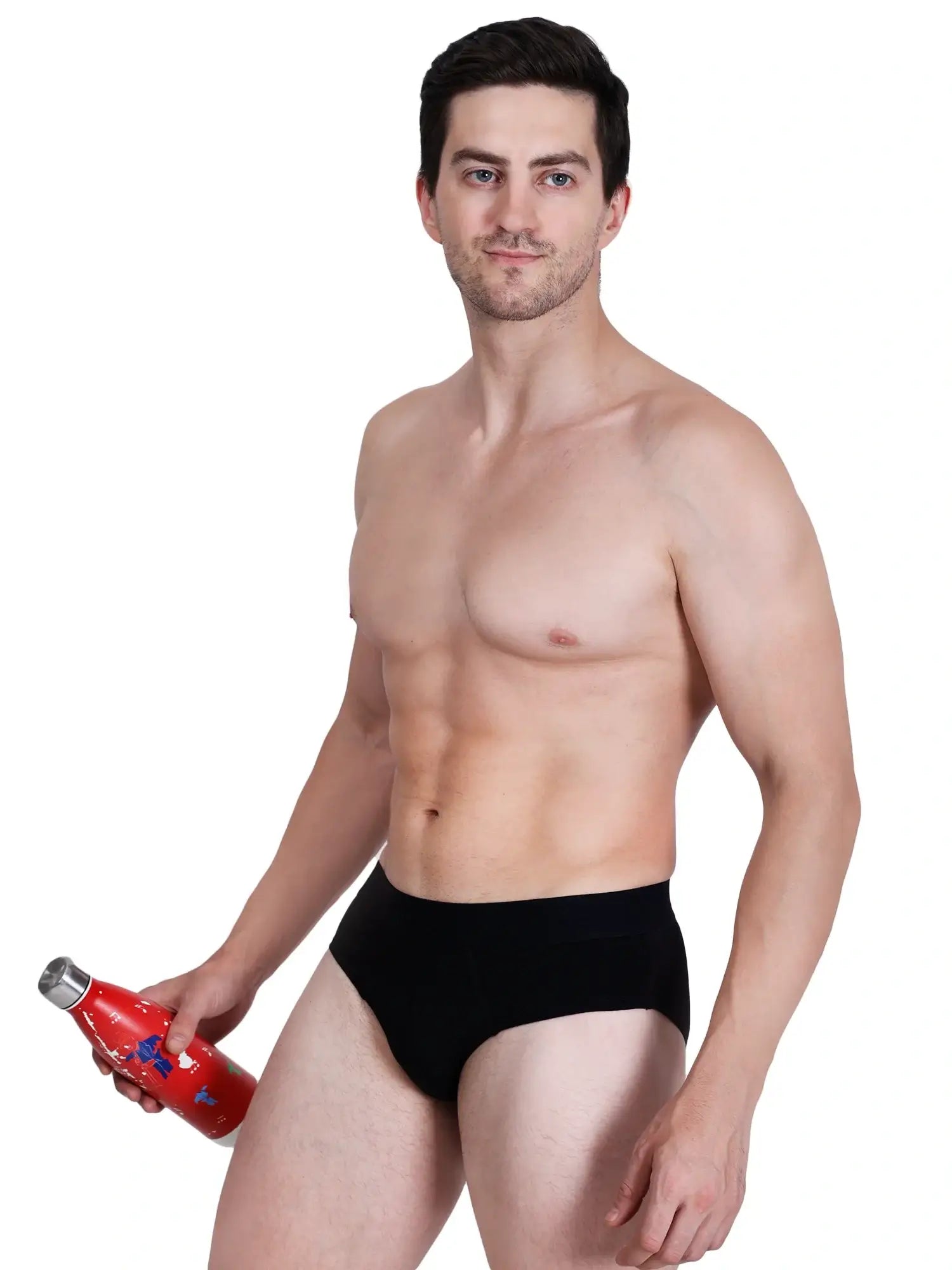 Man wearing black bamboo underwear, showcasing comfort and style, holding a water bottle.