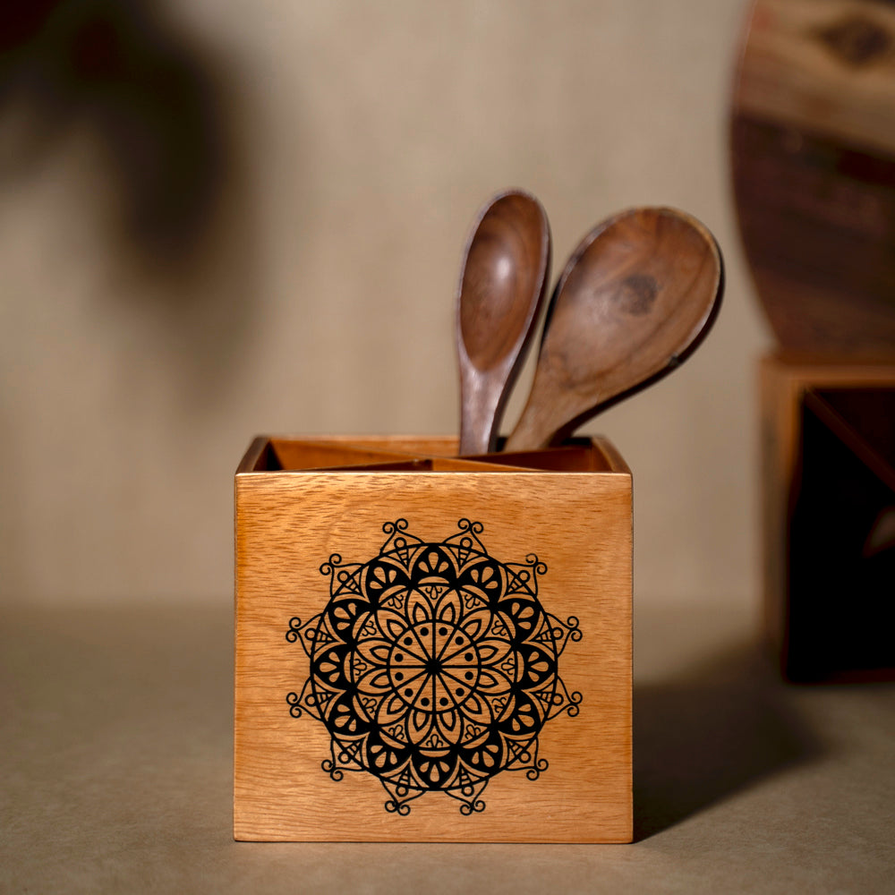 Infuse your kitchen with style using the Wood Light Spoon Stand, a lightweight and practical organizer made from Birch Wood. With removable 4 sections and adorned with Serenity Mandal Art, this stand seamlessly combines functionality and elegance, making it a perfect addition to your dining decor.