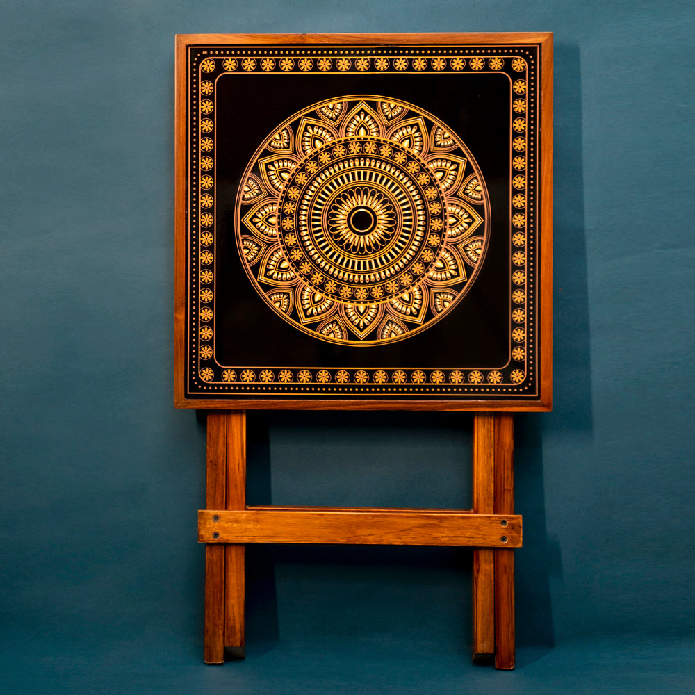 Enjoy the ease of complete foldability and effortless cleaning and maintenance. Elevate your surroundings with our Gold and Black Square Folding Table, designed for serenity. Crafted from teak wood and featuring Mandala Art.