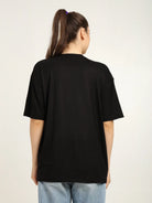 Person wearing a black t-shirt with a plain background